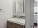 Bright bathroom features a modern vanity with stone backsplash and a large mirror at 9679 W Chatfield Ave # C, Littleton, CO 80128