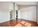 Spacious bedroom featuring hardwood floors, closet and ensuite laundry at 9679 W Chatfield Ave # C, Littleton, CO 80128