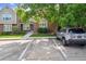 Townhouse exterior with assigned parking and mature trees in a well-maintained community at 9679 W Chatfield Ave # C, Littleton, CO 80128