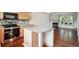 Open kitchen with hardwood floors, granite countertops, and stainless steel appliances at 9679 W Chatfield Ave # C, Littleton, CO 80128