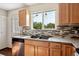 Kitchen area highlighting granite countertops, stainless steel appliances, and natural light at 9679 W Chatfield Ave # C, Littleton, CO 80128