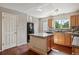 Well-lit kitchen featuring an island, stainless steel appliances, and hardwood floors at 9679 W Chatfield Ave # C, Littleton, CO 80128
