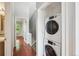 Hallway with stackable laundry, near bath, storage and bedroom at 9679 W Chatfield Ave # C, Littleton, CO 80128