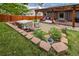 Backyard featuring a hot tub, pergola, and thoughtfully designed landscaping at 13642 Wrangler Way, Mead, CO 80542