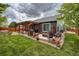 Spacious backyard with a pergola, hot tub, outdoor seating, and lush green grass at 13642 Wrangler Way, Mead, CO 80542