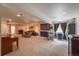 Large finished basement with neutral carpeting and multiple seating areas at 13642 Wrangler Way, Mead, CO 80542