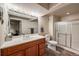 Bathroom featuring a well-lit vanity, tile flooring, and a glass-enclosed shower at 13642 Wrangler Way, Mead, CO 80542