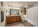 Bathroom featuring a double vanity, tiled floors, and shower-tub combo at 13642 Wrangler Way, Mead, CO 80542