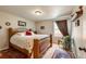 Cozy bedroom with hardwood floors, natural light, and a comfortable queen-sized bed at 13642 Wrangler Way, Mead, CO 80542