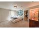 A bright bedroom with soft carpet, neutral walls, and a cozy bed at 13642 Wrangler Way, Mead, CO 80542
