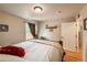 A cozy bedroom with warm lighting, hardwood floors, and comfortable furnishings at 13642 Wrangler Way, Mead, CO 80542