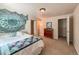 Cozy bedroom featuring an eclectic tapestry, neutral carpet, and lots of natural light at 13642 Wrangler Way, Mead, CO 80542