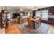 Open concept dining area features hardwood floors, natural light, and a decorative rug at 13642 Wrangler Way, Mead, CO 80542