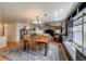 Dining room with hardwood floors, large window, and easy access to the living room at 13642 Wrangler Way, Mead, CO 80542