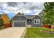 Charming single-Gathering home featuring a well-maintained lawn, two-car garage, and a beautifully landscaped front yard at 13642 Wrangler Way, Mead, CO 80542