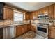 A modern kitchen featuring stainless steel appliances and stone tile flooring at 13642 Wrangler Way, Mead, CO 80542