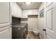 Laundry room featuring front loading washer/dryer, white cabinets, and tiled floors at 13642 Wrangler Way, Mead, CO 80542