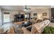 A sun-lit living room features a ceiling fan, hardwood flooring, and access to the backyard at 13642 Wrangler Way, Mead, CO 80542