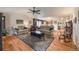 Inviting living room with hardwood floors, comfortable sofas, and a decorative rug, perfect for relaxation at 13642 Wrangler Way, Mead, CO 80542