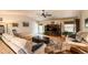 A bright living room with a ceiling fan, hardwood floors, and backyard access at 13642 Wrangler Way, Mead, CO 80542