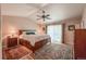 Spacious main bedroom featuring hardwood floors, ceiling fan, and a private patio at 13642 Wrangler Way, Mead, CO 80542