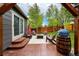 Stylish backyard patio featuring a pergola, outdoor furniture, and a decorative barrel at 13642 Wrangler Way, Mead, CO 80542