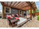 Charming patio area with pergola, comfortable seating, and decorative accents at 13642 Wrangler Way, Mead, CO 80542