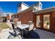 Outdoor dining and backyard view featuring a patio and adjacent entry to the brick home at 4729 W 32Nd Ave, Denver, CO 80212