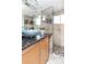 Updated bathroom features granite countertop, blue bowl sink, glass shower and mosaic tiled accent wall at 4729 W 32Nd Ave, Denver, CO 80212