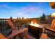 Outdoor deck shows a fire pit and comfortable wooden seating, perfect for relaxing and enjoying the view at 24045 High Meadow Dr, Golden, CO 80401