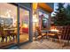 Inviting back deck features comfortable seating around a modern fire pit, and sliding glass doors at 24045 High Meadow Dr, Golden, CO 80401