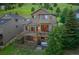 Expansive home exterior with a multi-level deck, outdoor seating, and a cozy hot tub, perfect for relaxation at 24045 High Meadow Dr, Golden, CO 80401