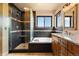 Bathroom featuring a modern shower, soaking tub, and dual vanities at 24045 High Meadow Dr, Golden, CO 80401