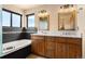 Double sink vanity, large soaking tub, and natural light in this bathroom at 24045 High Meadow Dr, Golden, CO 80401