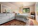Bright bedroom with a queen bed, large dresser, and decorative chandelier at 24045 High Meadow Dr, Golden, CO 80401