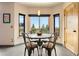 Bright breakfast nook area with a round table, four chairs, and a large window overlooking the outdoors at 24045 High Meadow Dr, Golden, CO 80401