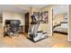 Home gym with an elliptical, desk, and access to a bedroom, providing convenient fitness options at 24045 High Meadow Dr, Golden, CO 80401