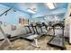 Well-equipped community gym with treadmills, rowing machines and large mirror at 24045 High Meadow Dr, Golden, CO 80401
