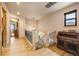 Hallway with hardwood floors, black iron railing, and view of the stairs at 24045 High Meadow Dr, Golden, CO 80401