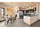 Stylish kitchen featuring stainless steel appliances, dark cabinetry, granite countertops, and a cozy breakfast nook at 24045 High Meadow Dr, Golden, CO 80401