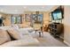 Cozy living room with a large sectional sofa, carpet, entertainment center, and view to the deck stairs at 24045 High Meadow Dr, Golden, CO 80401