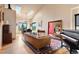 Bright open concept featuring skylights, a grand piano, hardwood floors, comfortable leather sofa, and views at 24045 High Meadow Dr, Golden, CO 80401