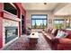 Cozy living room featuring fireplace, a large window with an outdoor view, and a ceiling fan at 24045 High Meadow Dr, Golden, CO 80401