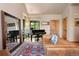 Inviting living room featuring a grand piano, a large mirror, a leather sofa, and beautiful hardwood floors at 24045 High Meadow Dr, Golden, CO 80401