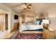 Main bedroom with a king bed, ceiling fan, and ensuite bath at 24045 High Meadow Dr, Golden, CO 80401