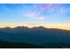 Scenic sunset over rolling mountain landscape, creating a serene backdrop with colorful sky and distant peaks at 24045 High Meadow Dr, Golden, CO 80401