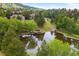 Picturesque pond with a charming gazebo surrounded by lush trees and landscaping at 24045 High Meadow Dr, Golden, CO 80401