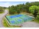 Aerial view of community tennis and pickleball courts surrounded by lush trees and scenic views at 24045 High Meadow Dr, Golden, CO 80401