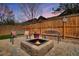 Cozy backyard features a fire pit and bench seating, perfect for outdoor enjoyment at 7823 E 130Th Pl, Thornton, CO 80602