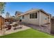 Landscaped backyard featuring a patio, artificial grass, stone details, and comfortable seating at 7823 E 130Th Pl, Thornton, CO 80602